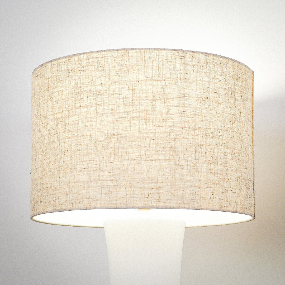 White ceramic lamp with gold accents and a classic silhouette.