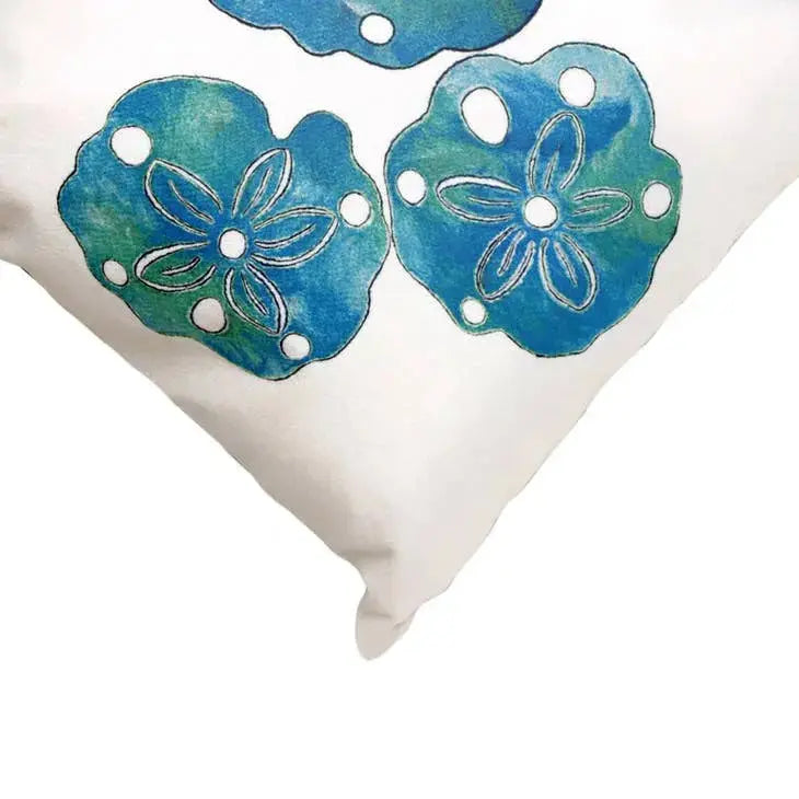 Closeup of textured sand dollar motif on indoor outdoor coastal pillow.