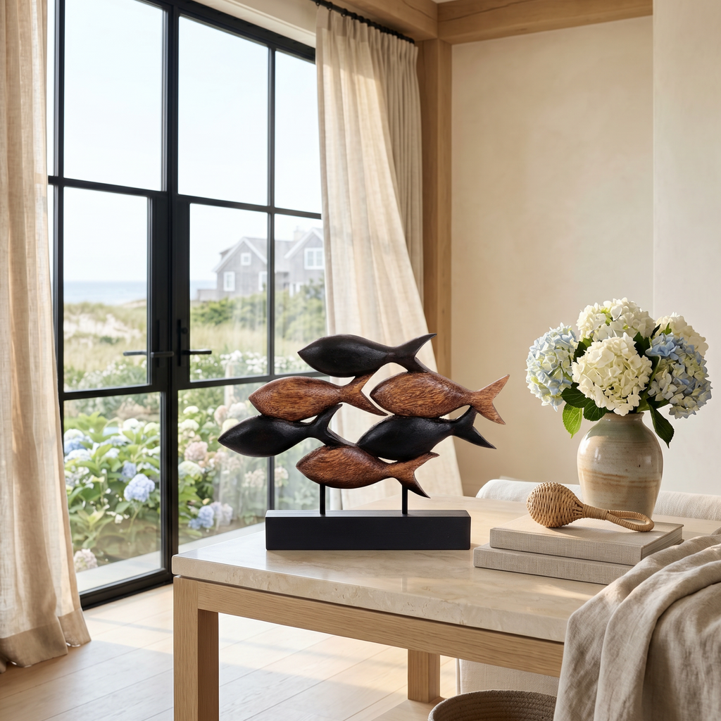 Carved wood fish sculpture on a mantel in a beach house style living room