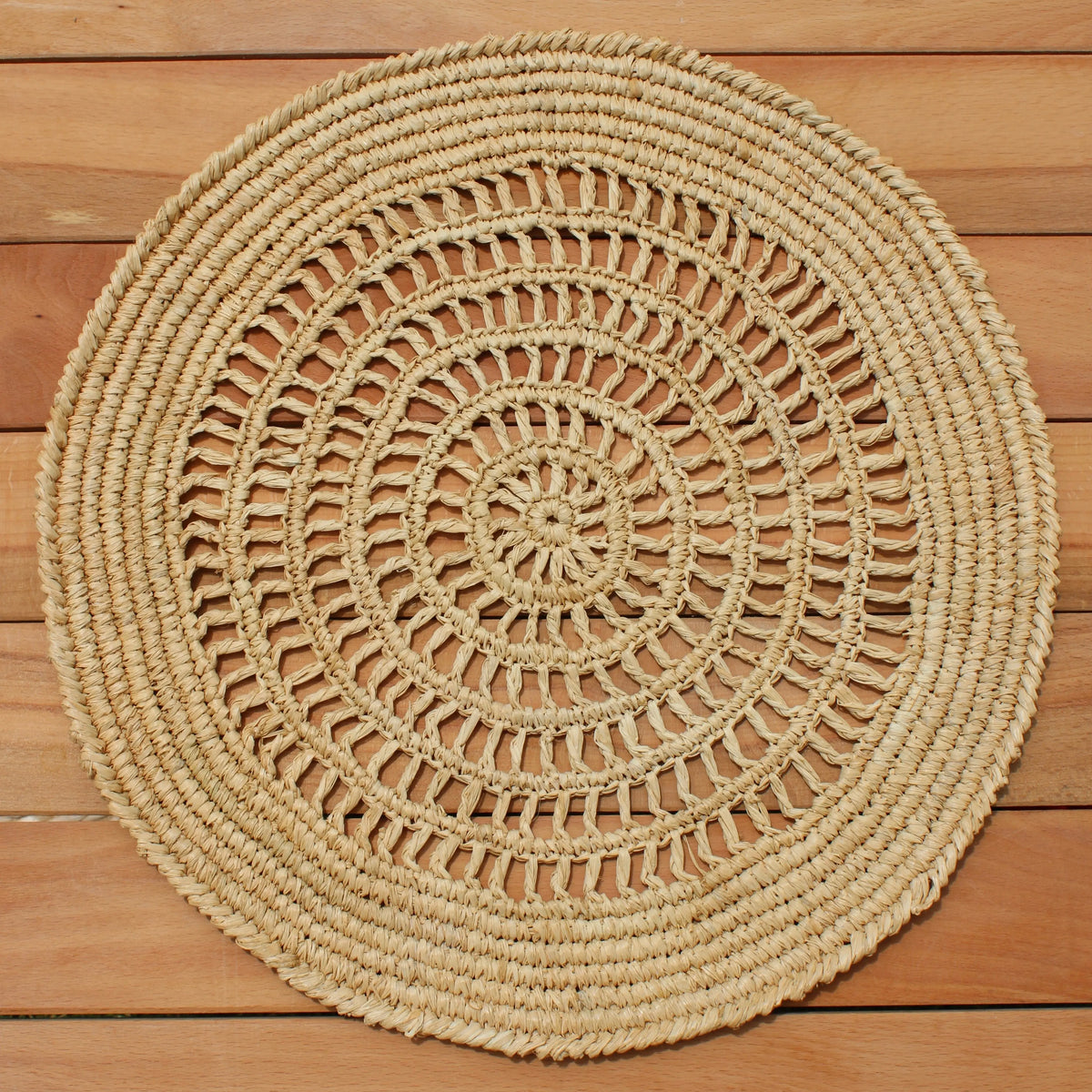 Woven coastal placemats adding natural texture to an elegant dining table.