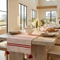 Woven red and white stripe table runner creating a casual coastal tablescape.