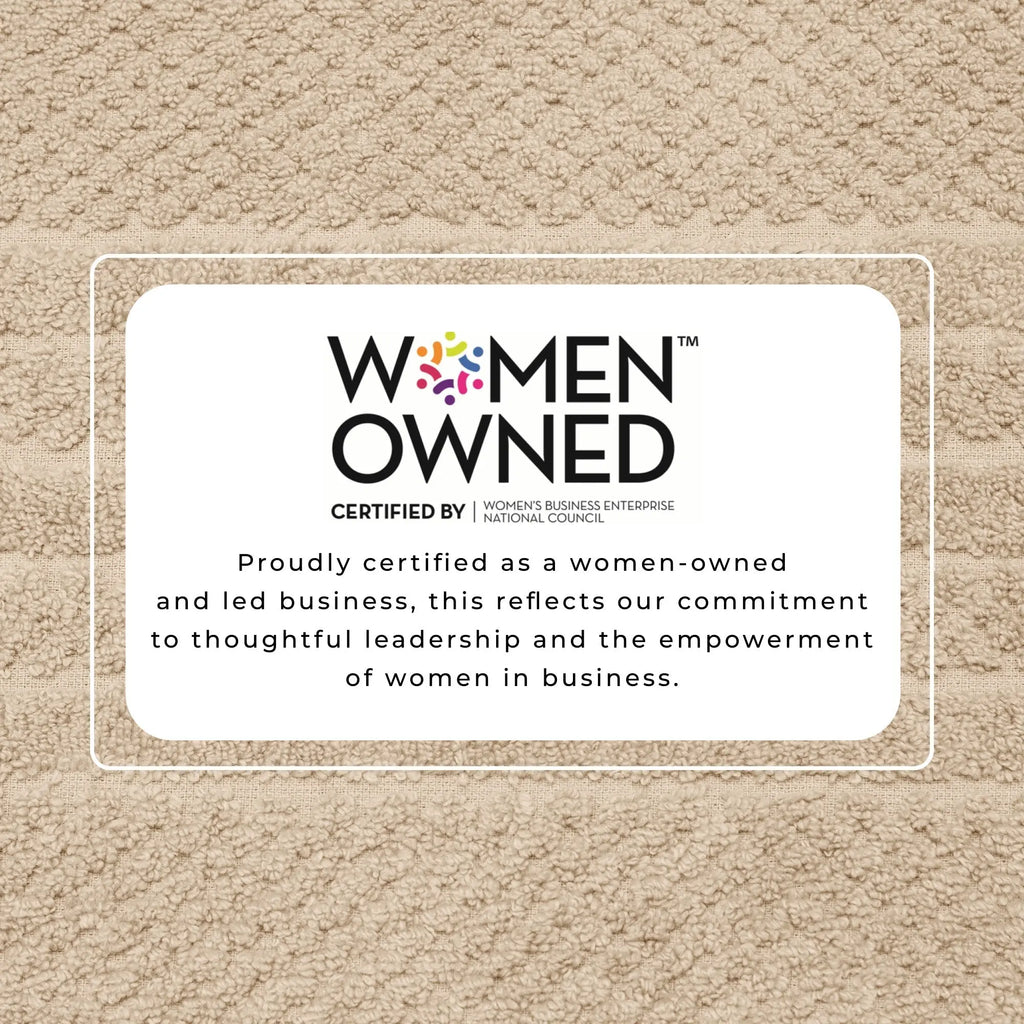 Beige bath towel background with a white Women Owned certification badge.